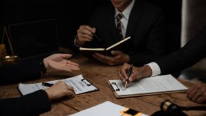 group of 3 people discussing legislation, while also filing paperwork